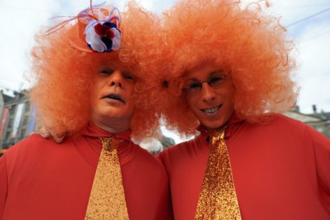 Two men wearing orange, the royal color, celebrated Queen Beatrix's abdication ceremony.
