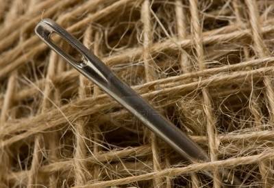 5914092-macro-of-sewing-needle-on-thread-clew-background