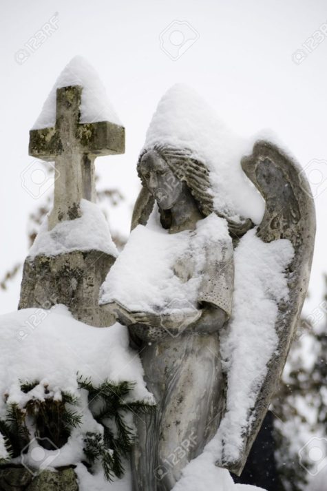 12185037-Close-up-of-a-stone-angel-statue-covered-with-snow-Stock-Photo